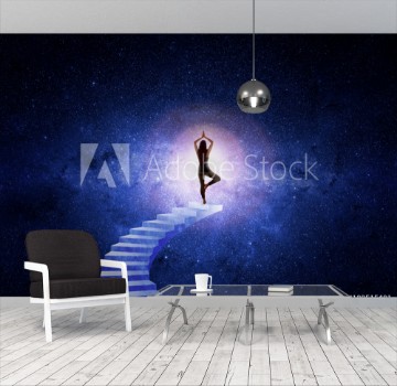 Picture of Woman in yoga position in front of the starry universe